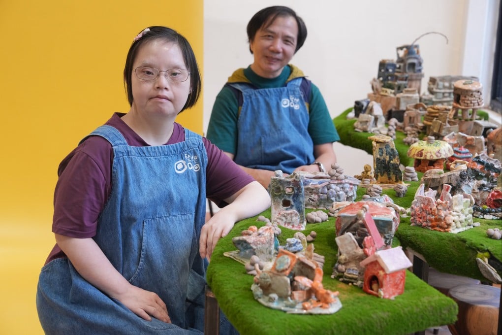 Lam Yuk-ying (left) and Ng Kwok-fai next to ceramic creations at the Morning Relay exhibition, in Wan Chai, Hong Kong, which features works by neurodiverse artists. Photo: May Tse