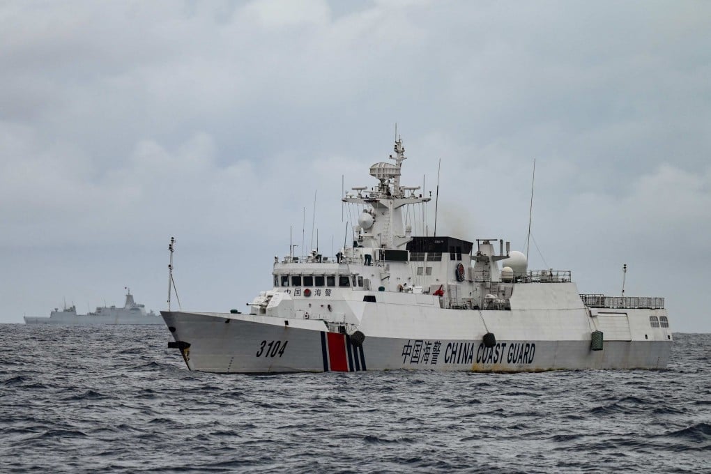 A China Coast Guard ship (right) and a vessel identified by the Philippine Coast Guard as a Chinese navy ship (background, left) are seen from a Philippine Coast Guard vessel in disputed waters of the South China Sea on August 26. Photo: AFP