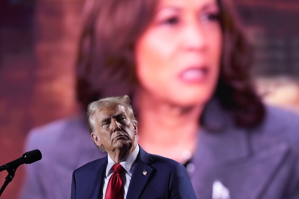 Donald Trump watches as a video featuring Democratic presidential nominee Vice-President Kamala Harris. Photo: AP