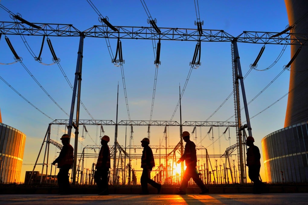 Workers walk in a power plant in the Shanghaimiao economic development zone in Otogqian Banner, north China’s Inner Mongolia Autonomous Region. Photo: Xinhua