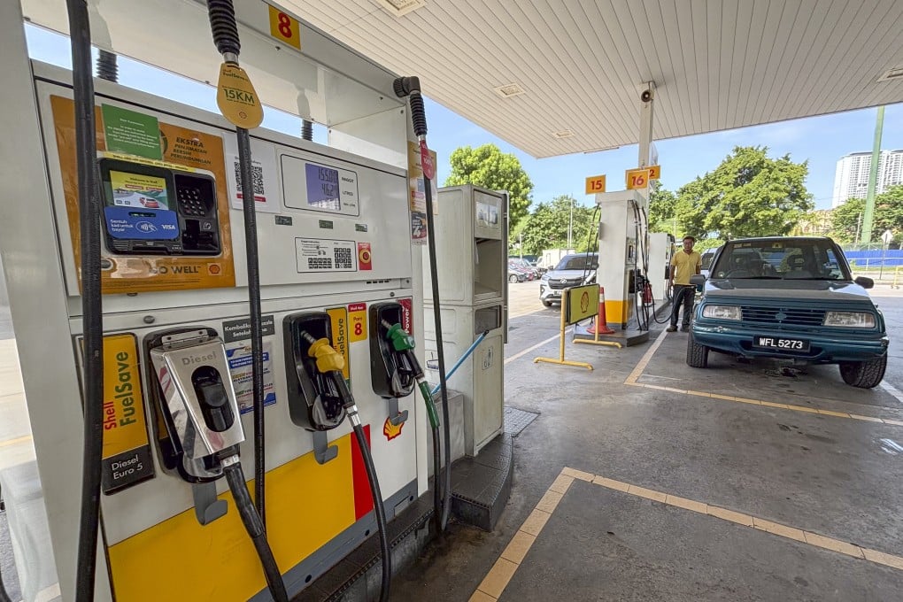 A car owner pumps at a petrol station in Kuala Lumpur, Malaysia. Anwar and his administration have faced public resentment over painful subsidy cuts to electricity, certain food items and, most recently, diesel. Photo: AP