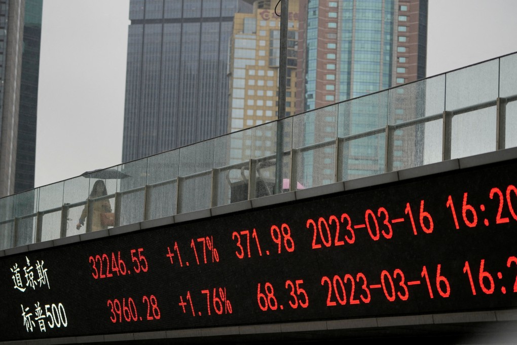 An electronic board shows stock indices at the Lujiazui financial district in Shanghai. Photo: Reuters