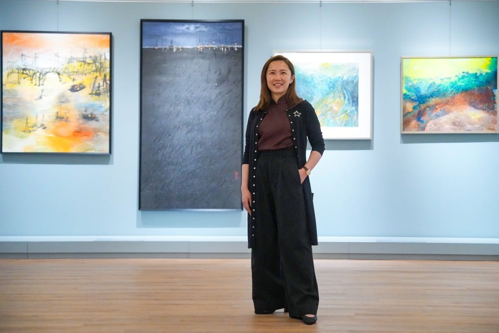 Chloe Sun, founder of Sun Museum, poses with artworks featured in the “Hong Kong Paintings in Sai Yuen Lane” exhibition, which brings together 92 local artists to celebrate the opening of the private museum’s new Sai Ying Pun location. Photo: May Tse