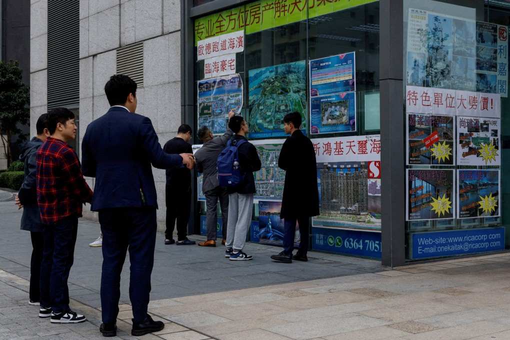Real estate agents introduce properties to clients, in Hong Kong in February 2024. Photo: Reuters