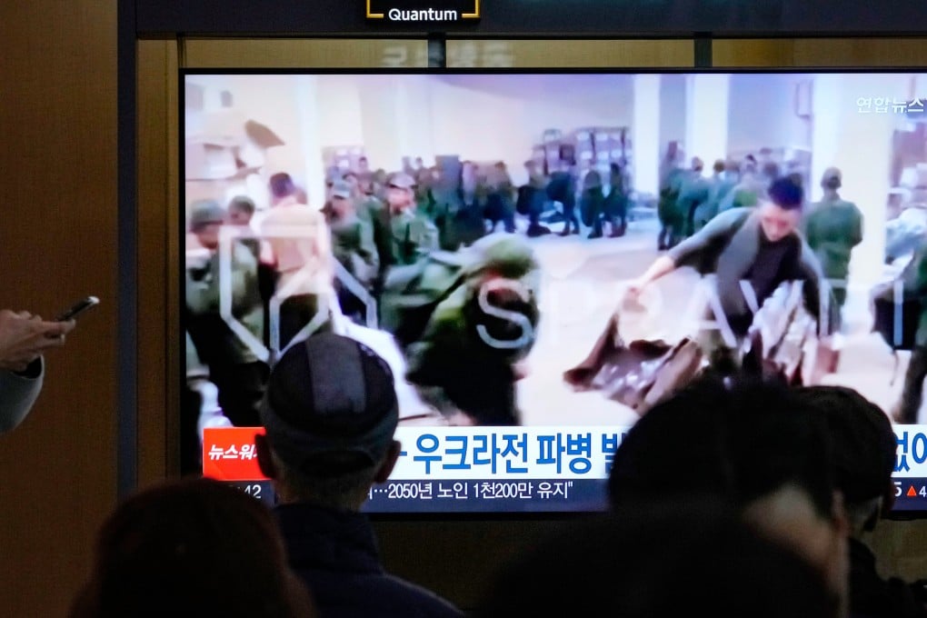 A TV screen at a Seoul railway station broadcast an image on Monday of soldiers, believed to be from North Korea, receiving supplies in Russia. Photo: AP