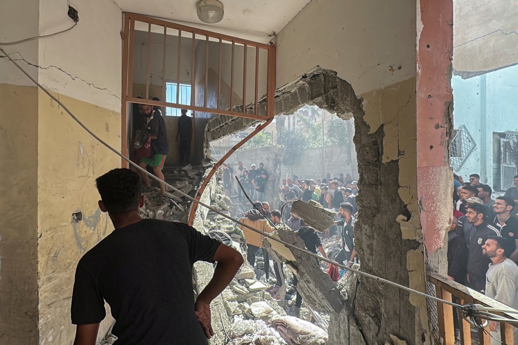 Palestinians inspect the site of an Israeli strike on a school sheltering displaced people, in Nuseirat in the central Gaza Strip. Photo: Reuters
