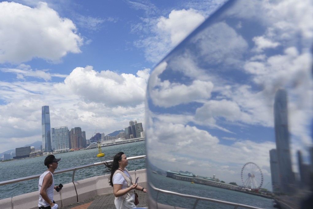 People walk along the waterfront on Hong Kong Island on September 5. Photo: Eugene Lee