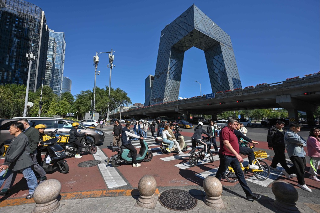 People crossed a road in Beijing’s business district. Photo: AFP