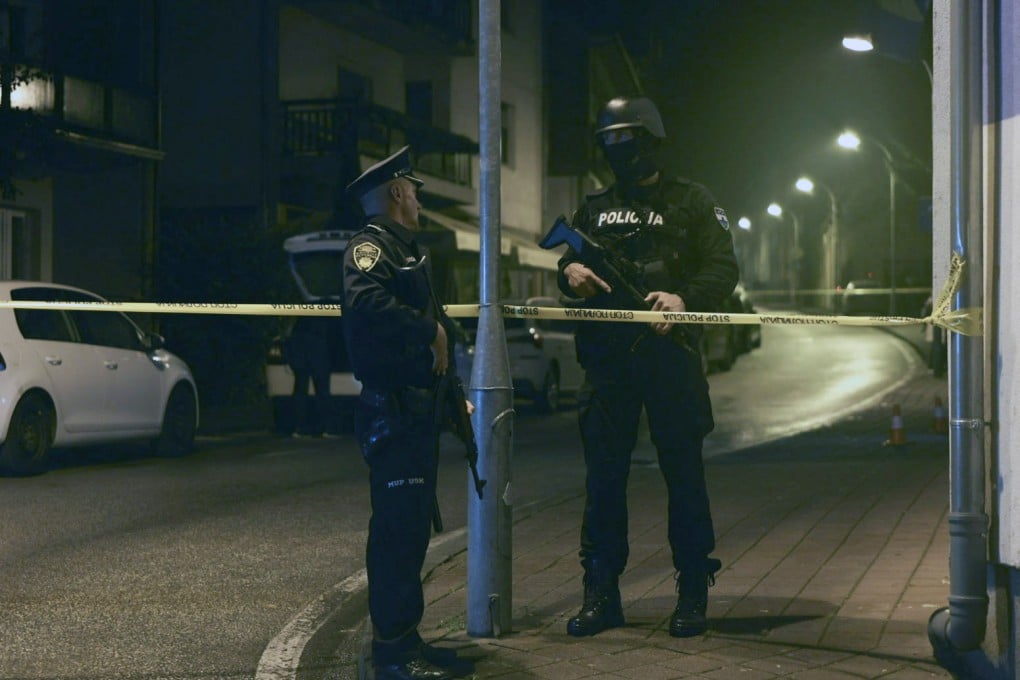 Bosnian police officers guard the local police station after a teenager broke and killed one officer with a knife and wounded another, in the town of Bosanska Krupa. Photo: AP
