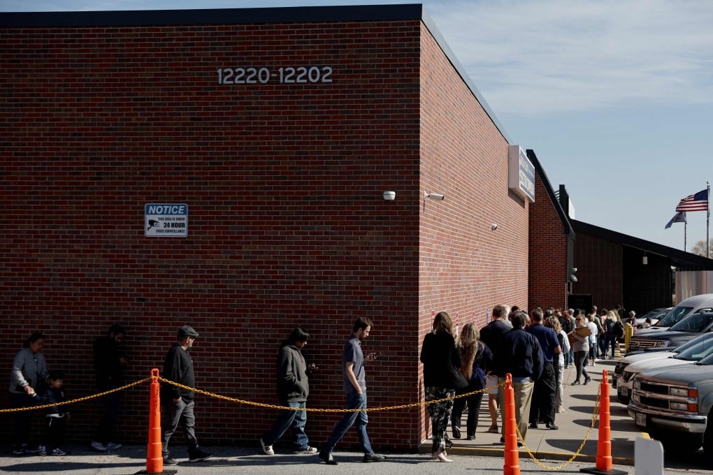 People wait in line to cast early ballots or register to vote outside the Douglas County Election Commission on October 24 in Omaha, Nebraska. Photo: AFP