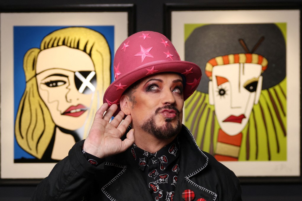 Boy George poses in front of his portrait of Madonna (left) and a self-portrait of himself during his Culture Club days from “Fame”, a limited-edition collection with British art retailer Castle Fine Art, on October 23, 2024. Photo: Reuters