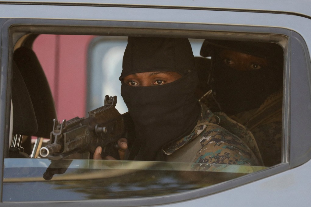 Security personnel escort the car of a member of Haiti’s presidential council in Port-au-Prince, Haiti. Photo: Reuters