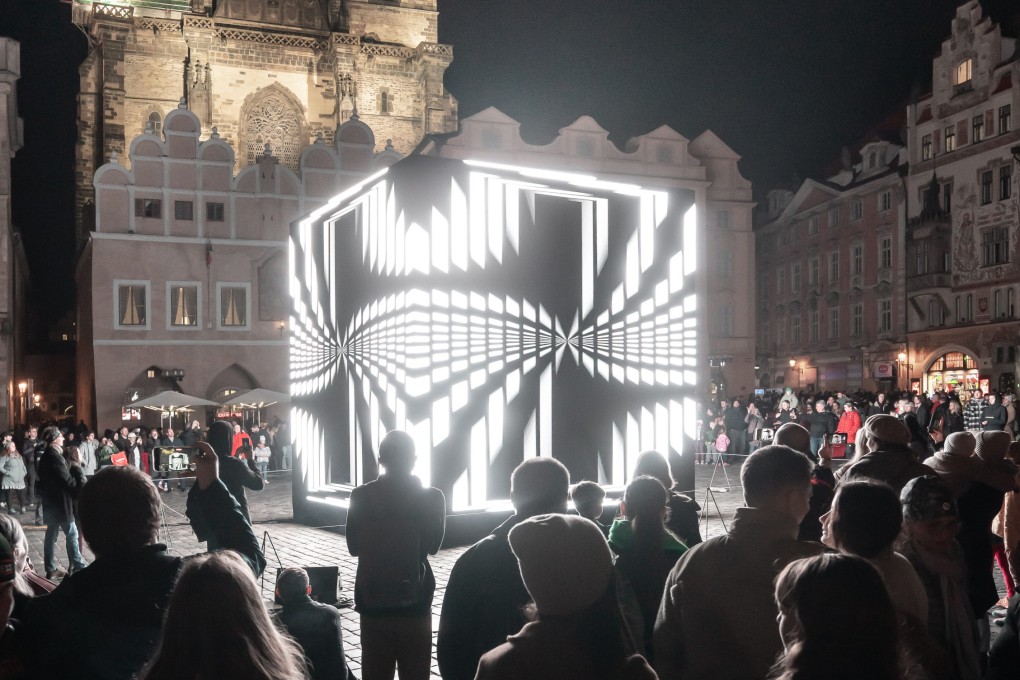 A crowd gathers in Prague’s Old Town Square around Chinese artist Cao Yuxi’s “Dimensional Sampling”, a piece of light art with sound by Hong Kong’s Lawrence Lau that was part of the Signal Festival 2024, in the Czech Republic. Photo: Signal Festival