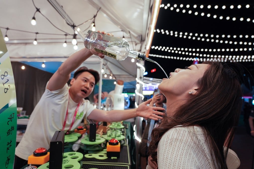 Visitors take part in a drinking competition at the Wine & Dine Festival in Central on October 23. Photo: Eugene Lee