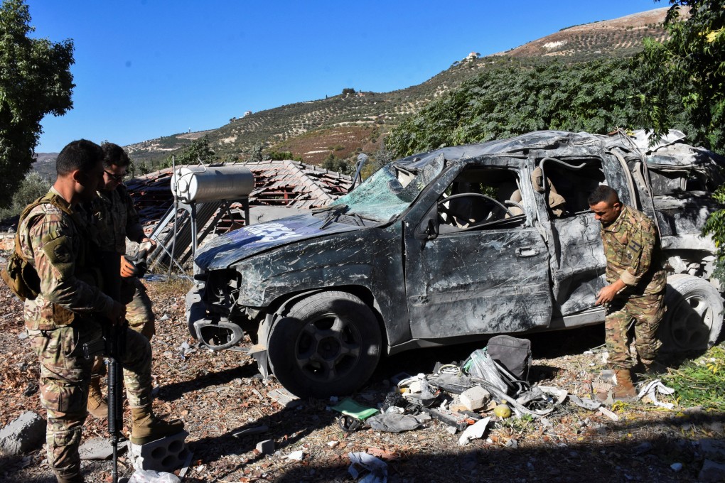 Lebanese army soldiers inspect a destroyed vehicle marked with ‘Press’ at the site of an Israeli strike. Photo: Reuters