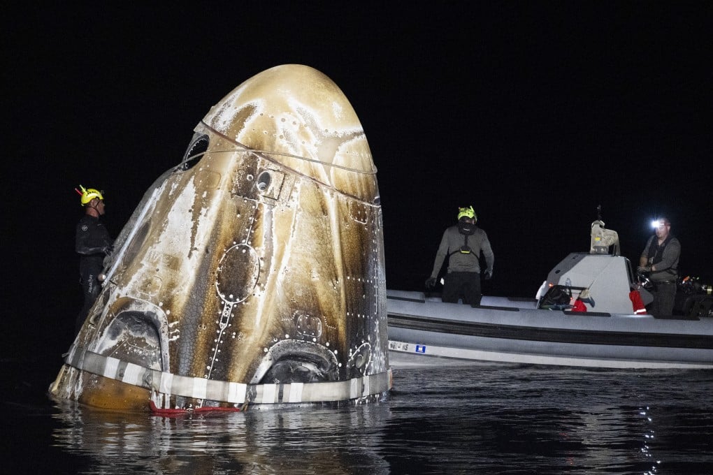 Support teams work around the SpaceX Dragon Endeavour spacecraft shortly after it landed in the Gulf of Mexico off the coast of Pensacola, Florida, on Friday. Photo: Nasa via AP