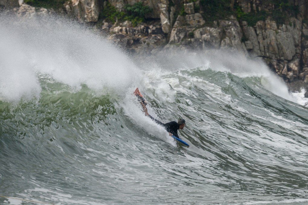 Surfers take advantage of the waves whipped up by Severe Tropical Storm Trami, at Big Wave Bay Beach, Hong Kong. Photo: SCMP / Antony Dickson