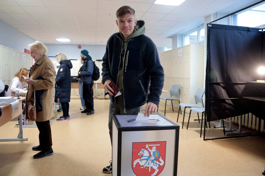 A man casts his ballot during the second round of parliamentary elections at a polling station in Vilnius, Lithuania, on Sunday. Photo: AFP