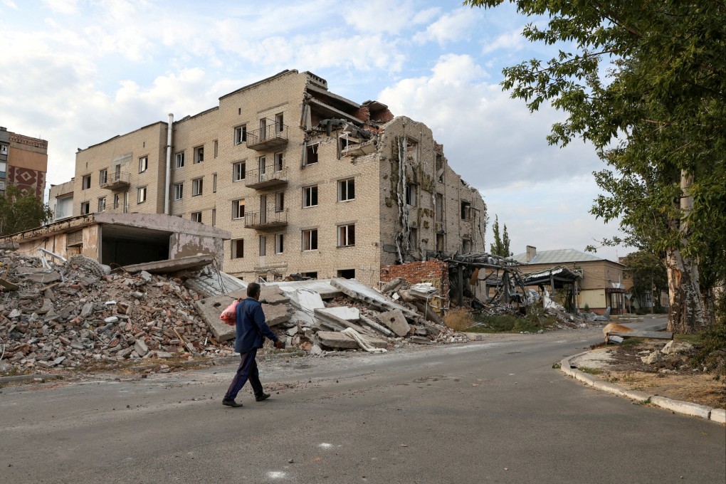 A man walks past a building damaged by a Russian military strike in the town of Pokrovsk. File photo: Reuters