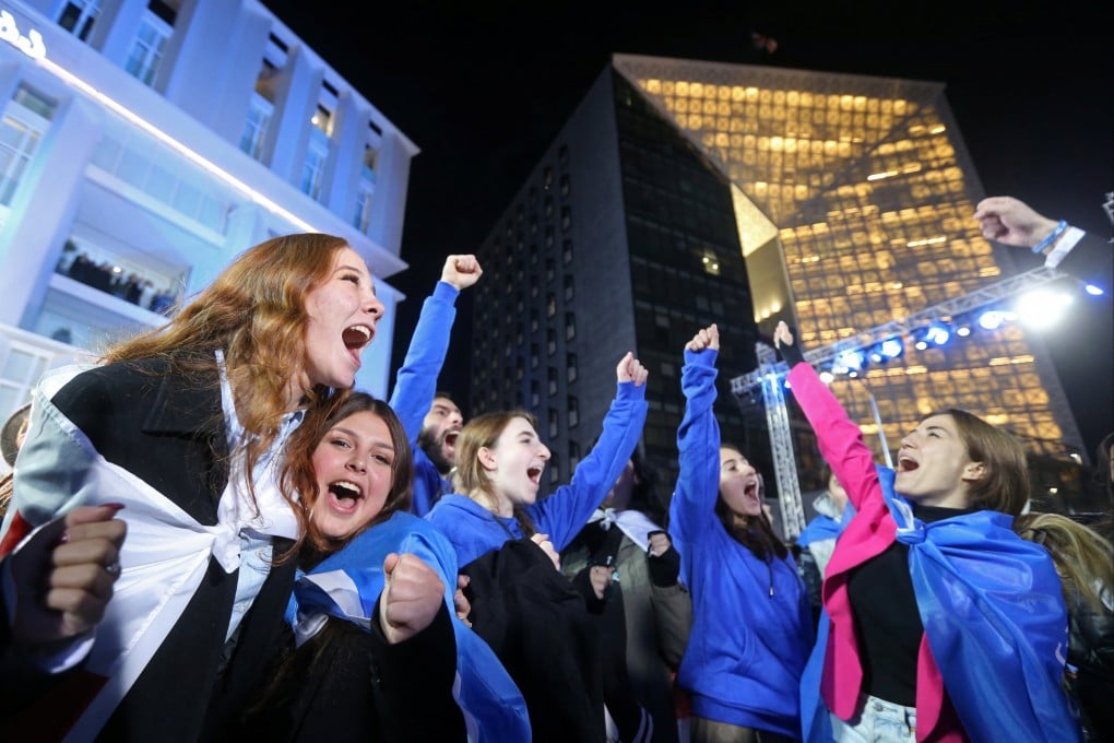 Georgian Dream supporters celebrate at the party’s headquarters after the announcement of exit poll results in Tbilisi on Saturday. Photo: Reuters