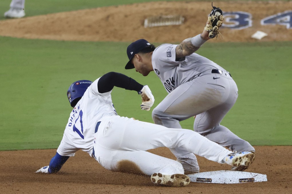 LA Dodgers designated hitter Shohei Ohtani (bottom) is caught stealing second base in the seventh inning of Game 2 of the World Series against the New York Yankees. Photo: Kyodo