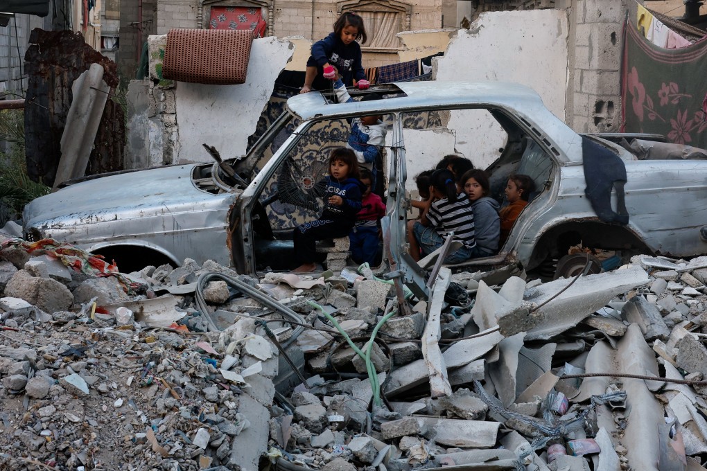 Palestinian children gather at a destroyed vehicle in Khan Younis, in the southern Gaza Strip. Photo: Reuters