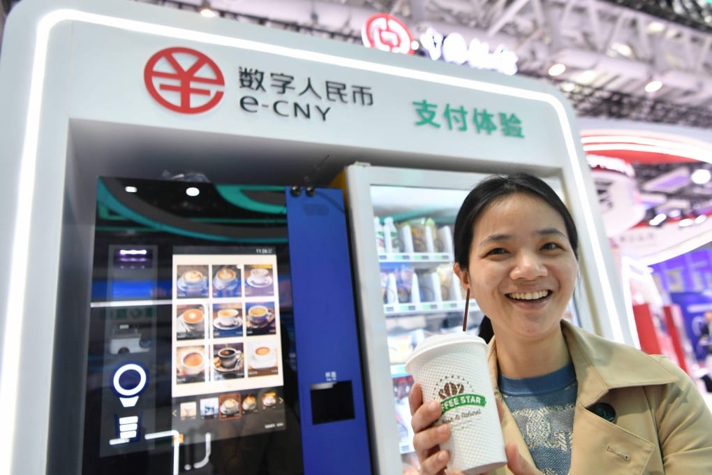 A visitor displays a cup of coffee bought with China’s digital yuan, or the e-CNY, at the Digital China Summit in Fuzhou, Fujian province, on April 26, 2023. Photo: Xinhua