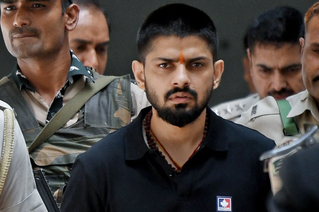 Policemen escort Lawrence Bishnoi at a court in New Delhi in April 2023. Photo: ANI/Handout via Reuters