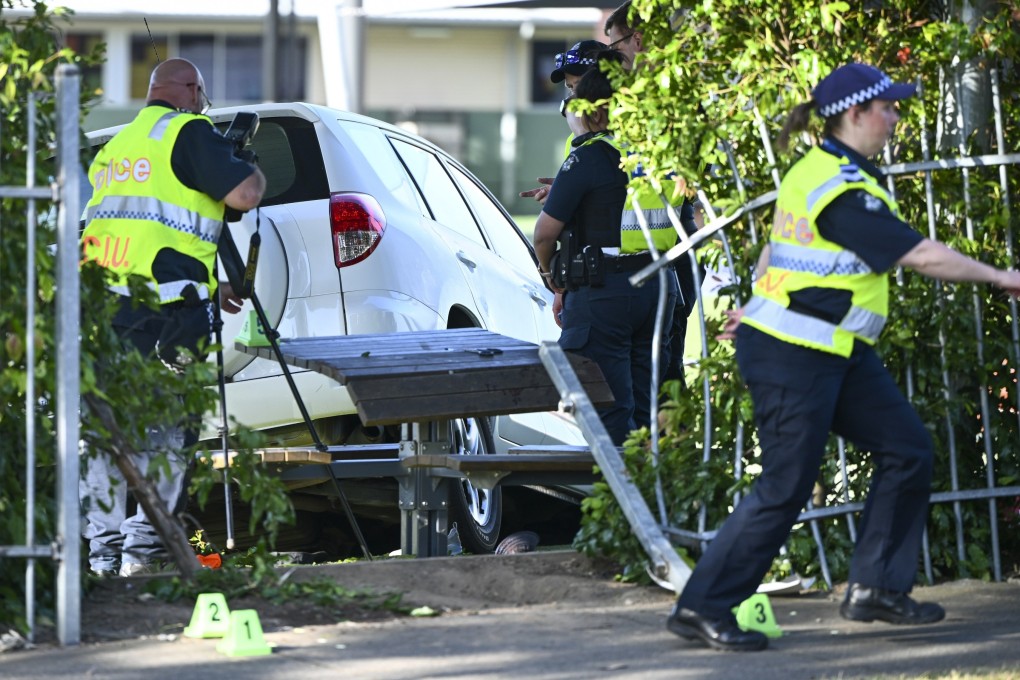 Police officers attend to the scene of an accident where a car crashed through a school fence in Melbourne, Australia, on Tuesday. Photo: AAP Image via AP