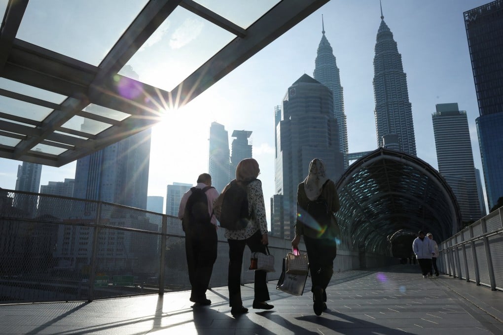 People walk to their workplace during the morning rush at Kuala Lumpur city centre. Photo: Reuters