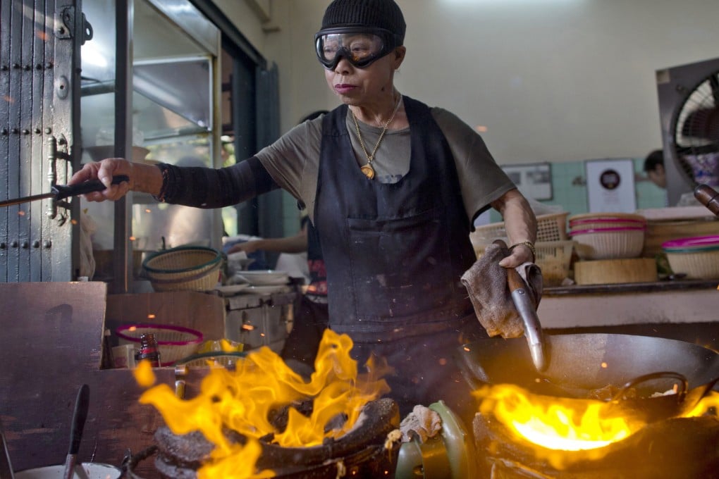 Thai street-food cook Jay Fai, awarded a Michelin star in 2018 and known for her crabmeat omelette, may be hanging up her signature ski googles as soon as next year. Photo: AP
