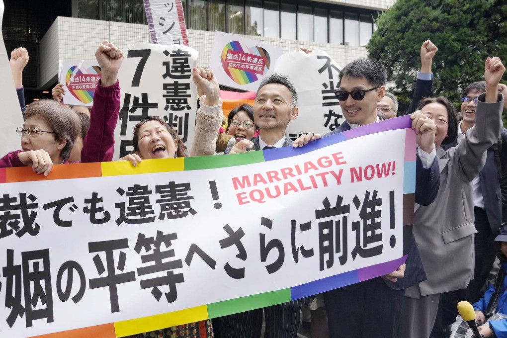 Plaintiffs rejoice outside the Tokyo High Court on Wednesday after it ruled that Japan’s lack of legal recognition for same-sex marriage is unconstitutional. Photo: Kyodo