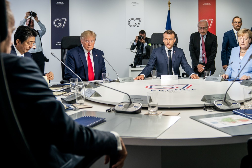 Then-Japanese prime minister Shinzo Abe (far left), then-US president Donald Trump (centre left), French president Emmanuel Macron (centre) and then-German chancellor Angela Merkel (far right) attend a meeting of the G7 summit in Biarritz, France, on August 26, 2019. Photo: dpa