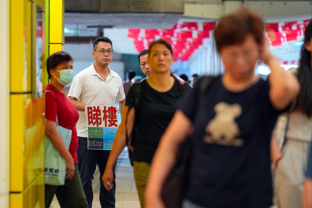 A property agent seeks business at the Wong Chuk Hang MTR station. Photo: Sam Tsang