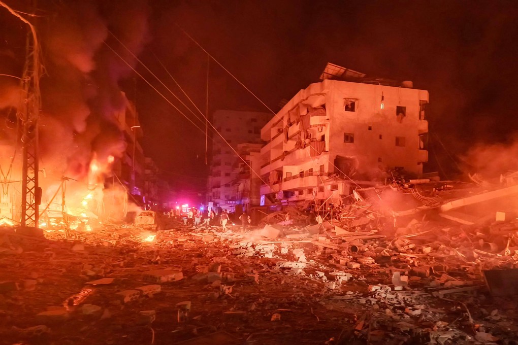 First responders work after an Israeli air strike that targeted the industrial zone in the southern Lebanese village of Abbasiyeh on Wednesday. Photo: AFP