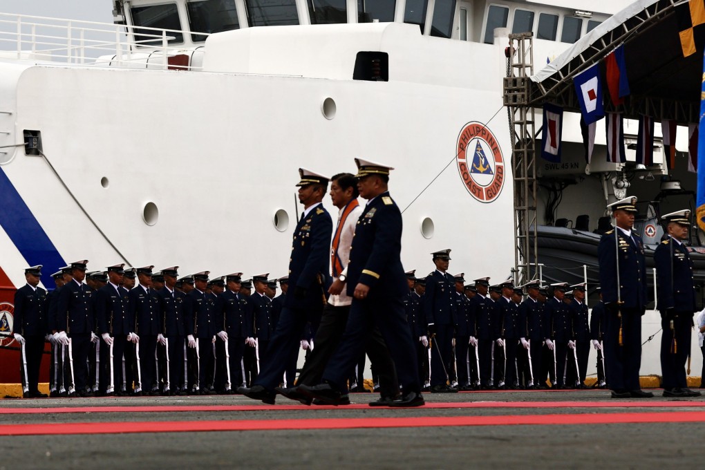 Philippine President Ferdinand Marcos Jnr reviews coastguard personnel next to the patrol ship BRP Gabriela Silang on October 22. Photo: EPA-EFE