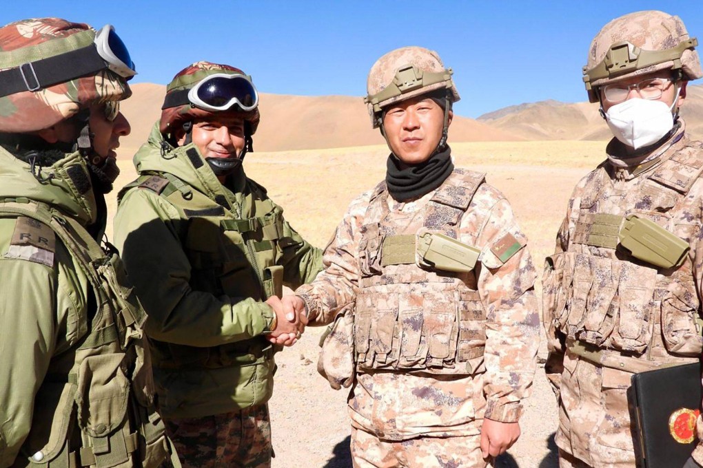 Indian and Chinese army members greet each other along the Line of Actual Control near Karakoram pass in Ladakh on October 31, on the occasion of Diwali. Photo: Indian Army/AFP