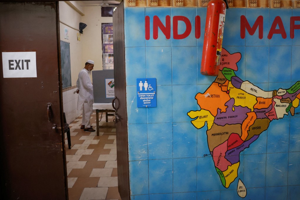 A man votes inside a booth at a polling station during the sixth phase of the general election, in the old quarters of Delhi, India, in May. Photo: Reuters