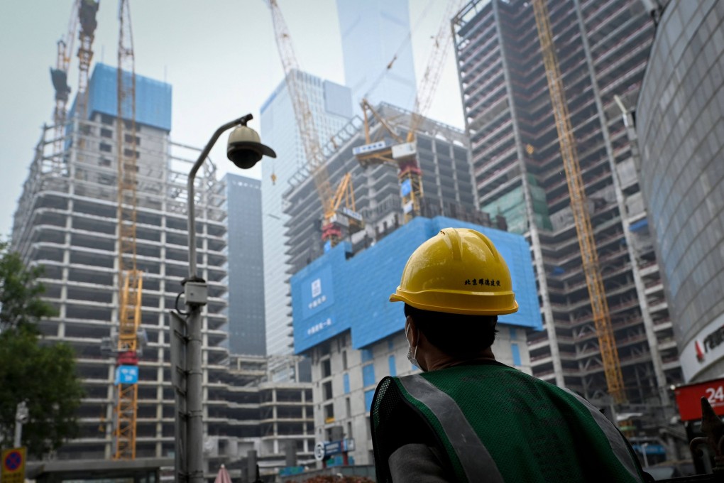 A worker walks past a construction site in Beijing. Photo: AFP