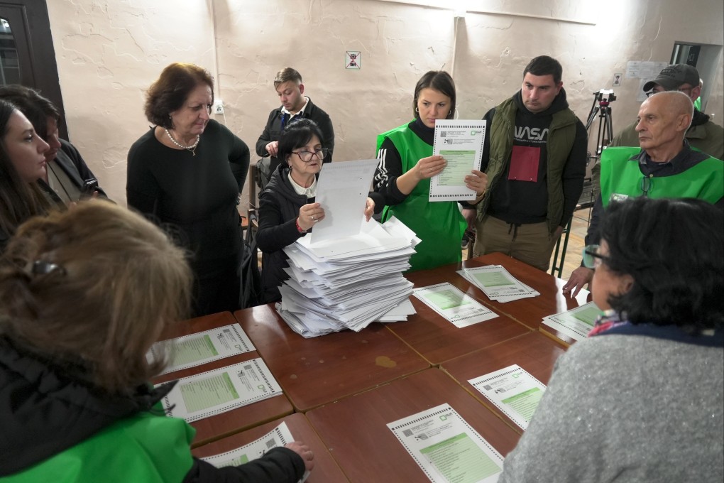 Members of an election commission count ballots at a polling station after the parliamentary election in Tbilisi, Georgia on October 26. Photo: AP