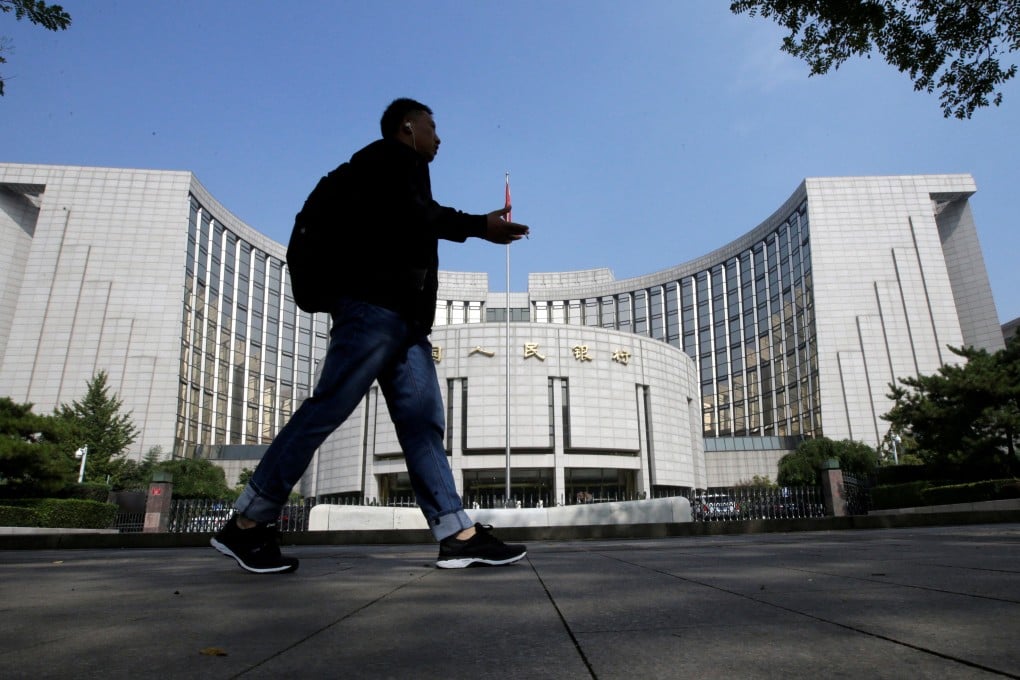 A man walks past the headquarters of the People’s Bank of China in Beijing. Photo: Reuters