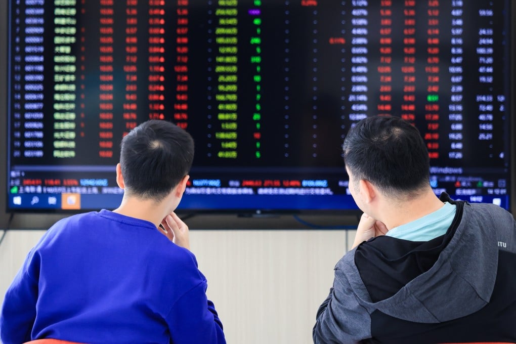 Investors pay attention to the stock market trends at a securities firm in Nanjing, east China’s Jiangsu province. Photo: Xinhua