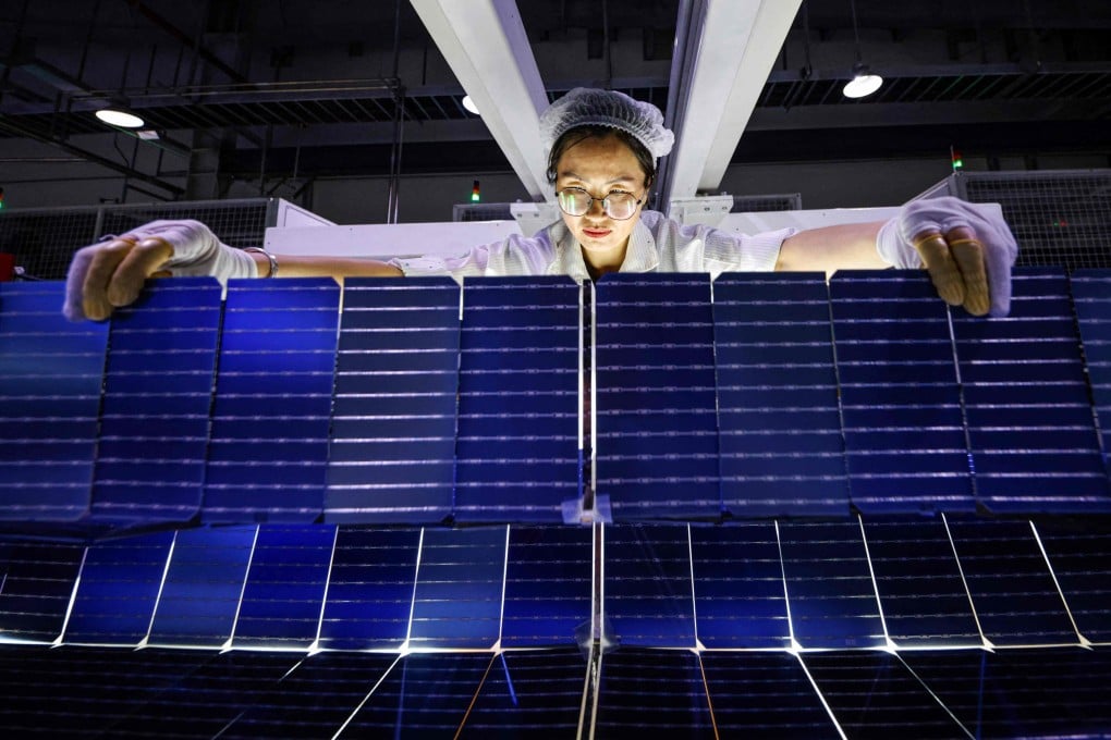 An employee works on solar photovoltaic modules for export at a factory in Sihong, in Jiangsu province, on September 3. Strong state support and huge private investment have made China’s solar industry a global powerhouse, but it faces new headwinds including punitive tariffs and a brutal price war at home. Photo: AFP
