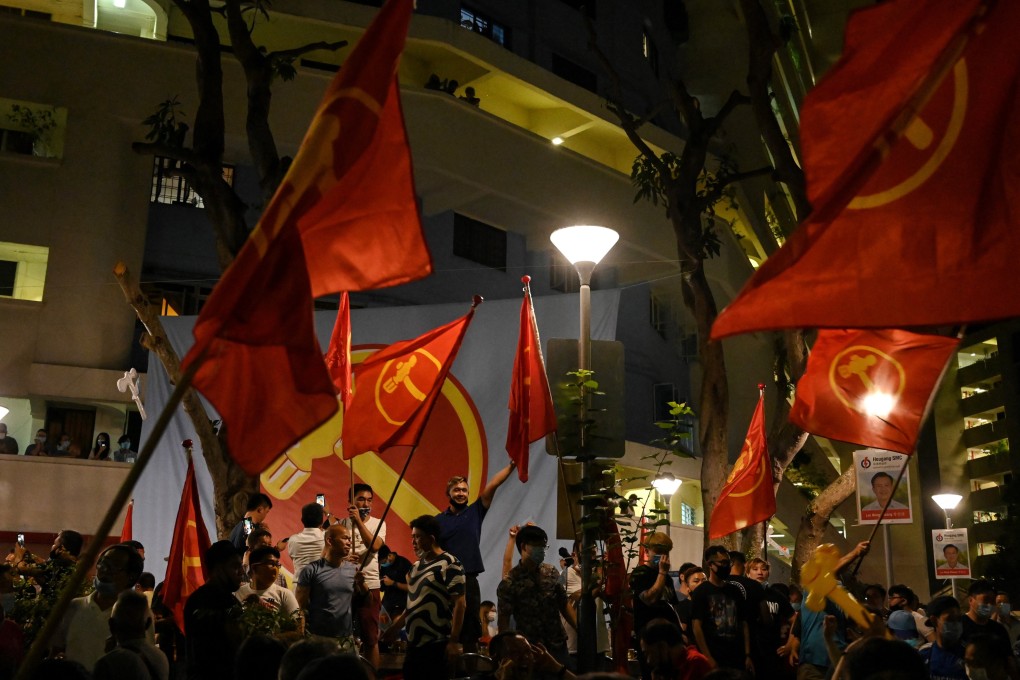 Supporters of the opposition Workers’ Party wave party flags as they gather in Hougang after the general election in 2020. Photo: AFP