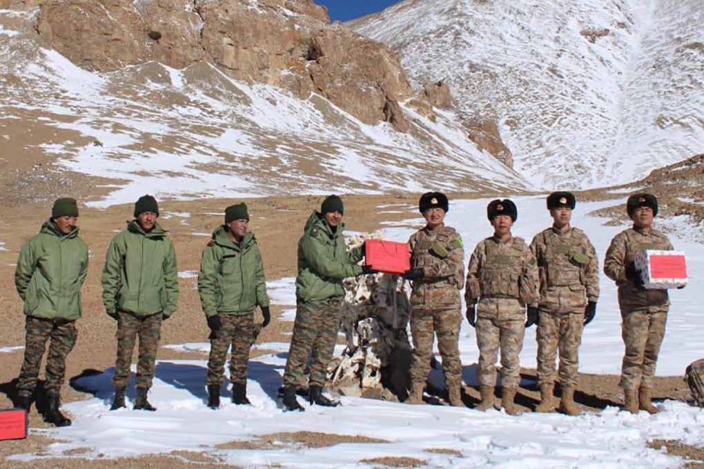 Indian and Chinese soldiers greet each other along the Line of Actual Control near Karakoram Pass on Thursday. Photo: AFP