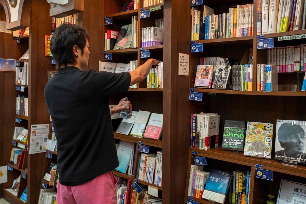 Rokurou Yui checks shelves at one of his three shelf-sharing bookstores in Tokyo’s Kanda Jimbocho district, known for its booksellers. Under a new business model, anyone can rent a shelf to sell books, new and used, giving readers more eclectic choices than those suggested by algorithms online. Photo: AFP