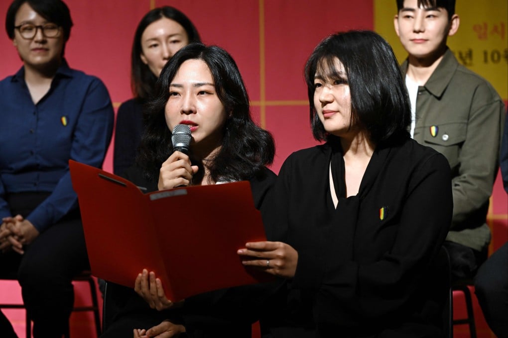Kim Sae-yeon (left) and her partner Kim Kyu-jin speak during a press conference at which they and 10 other Korean same-sex couples announced their intention to file a lawsuit against district offices’ rejection of their marriage registrations. Photo: AFP