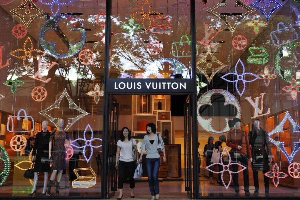 Shoppers walk out of a Louis Vuitton store in Tokyo’s Omotesando fashion district. Photo: EPA-EFE