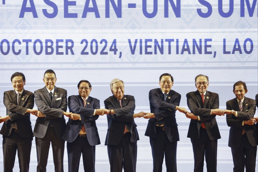 Singaporean Prime Minister Lawrence Wong, Thai Minister of Foreign Affairs Maris Sangiampongsa, Vietnamese Prime Minister Pham Minh Chinh, UN Secretary-General Antonio Guterres, Laotian Prime Minister Sonexay Siphandone, Malaysian Prime Minister Anwar Ibrahim and Brunei’s Sultan Hassanal Bolkiah hold hands during a “family photo” at the 14th Asean-United Nations Summit in Vientiane, Laos, on October 11. Photo: EPA-EFE
