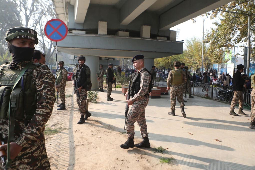 Indian police and paramilitary soldiers stand guard near the site of a grenade explosion in Srinagar, Kashmir on Sunday. Photo: EPA-EFE